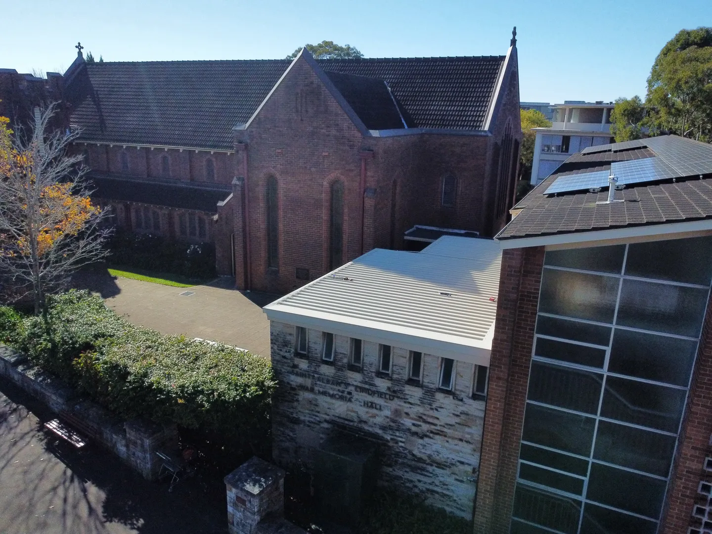 Aerial view of historic church building in sunlight.